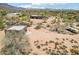 A broad view of the property and its surrounding landscape, including a home, garage, and stable at 10600 E Cordova St, Gold Canyon, AZ 85118