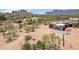 An aerial view shows the desert landscape surrounding the home and the separate garage at 10600 E Cordova St, Gold Canyon, AZ 85118