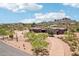 Aerial view of a desert home highlighting mountain views, landscaping, and its desert oasis setting at 10600 E Cordova St, Gold Canyon, AZ 85118