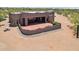 Aerial view of a desert home's patio featuring a curved retaining wall and decorative succulents at 10600 E Cordova St, Gold Canyon, AZ 85118