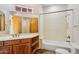 Bathroom featuring wood cabinetry, a bathtub with shower, and a large mirror at 10600 E Cordova St, Gold Canyon, AZ 85118