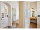Hallway view into the bathroom, featuring tile floors and glass block details at 10600 E Cordova St, Gold Canyon, AZ 85118