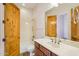 Bright bathroom with wood door, single sink vanity, and tub/shower combo at 10600 E Cordova St, Gold Canyon, AZ 85118