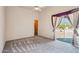 Bright bedroom with carpeted floors, ceiling fan, and access to a private patio with desert views at 10600 E Cordova St, Gold Canyon, AZ 85118