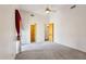 Bright, spacious bedroom featuring carpeted floors, ceiling fan, and two wood paneled doors at 10600 E Cordova St, Gold Canyon, AZ 85118