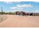Home with multiple garages, covered walkways, and a circular driveway amid natural desert landscaping at 10600 E Cordova St, Gold Canyon, AZ 85118