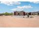 Spacious home with multiple garages and Southwestern-style design surrounded by desert landscaping and mountain views at 10600 E Cordova St, Gold Canyon, AZ 85118