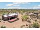 Aerial view of custom desert home showcasing large red patio and desert landscape at 10600 E Cordova St, Gold Canyon, AZ 85118