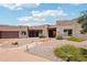 Beautiful Southwestern-style home with desert landscaping, a paver walkway, and a welcoming covered entrance at 10600 E Cordova St, Gold Canyon, AZ 85118