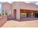 A back view of the home with patio and surrounding desert landscaping, seamlessly blending indoor and outdoor living at 10600 E Cordova St, Gold Canyon, AZ 85118