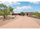Southwestern home featuring mature trees, circular drive and spacious desert front yard at 10600 E Cordova St, Gold Canyon, AZ 85118