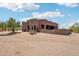 Desert home's exterior featuring a backyard patio area, complementing natural beauty, and a low-maintenance landscape at 10600 E Cordova St, Gold Canyon, AZ 85118