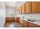 Functional laundry room with ample cabinet space, granite countertops, and a stainless steel sink at 10600 E Cordova St, Gold Canyon, AZ 85118