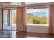 Bright living room featuring tile flooring, sliding glass doors to patio with desert mountain views at 10600 E Cordova St, Gold Canyon, AZ 85118