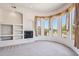 Cozy living room featuring a fireplace with built-in shelving and views of the desert landscape at 10600 E Cordova St, Gold Canyon, AZ 85118
