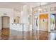 Bright living room featuring tile flooring, high ceilings, and a solid wood entry door at 10600 E Cordova St, Gold Canyon, AZ 85118