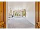Open-concept living room with carpet flooring, a fireplace, and large windows at 10600 E Cordova St, Gold Canyon, AZ 85118