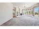 Spacious living room featuring large windows with desert views, fireplace, and elegant curtains at 10600 E Cordova St, Gold Canyon, AZ 85118