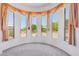 Sun-drenched living room with a curved wall of windows offering panoramic views of the surrounding landscape at 10600 E Cordova St, Gold Canyon, AZ 85118