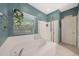 Bathroom features a soaking tub, walk-in shower, and large window for natural light at 10746 W Desert Elm Ln, Peoria, AZ 85383