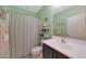 Cozy bathroom with a single vanity, toilet, and tub with a striped shower curtain at 10746 W Desert Elm Ln, Peoria, AZ 85383