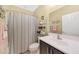 Cozy bathroom with a shower-tub combo and a stylish vanity featuring shelving and decor at 10746 W Desert Elm Ln, Peoria, AZ 85383