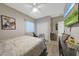 Bright bedroom featuring a ceiling fan, wood-style flooring, and a closet with sliding doors at 10746 W Desert Elm Ln, Peoria, AZ 85383