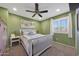 Light filled bedroom with a ceiling fan, a white framed bed, and a picturesque window at 10746 W Desert Elm Ln, Peoria, AZ 85383
