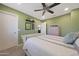Charming bedroom with a ceiling fan, white trim and an inspiring accent wall decor at 10746 W Desert Elm Ln, Peoria, AZ 85383