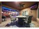Charming covered patio featuring outdoor seating, a ceiling fan, and access to the backyard pool area at 10746 W Desert Elm Ln, Peoria, AZ 85383