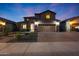 Charming two-story home boasts a well-maintained front yard, a brick driveway, and a welcoming entrance at 10746 W Desert Elm Ln, Peoria, AZ 85383