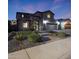 Elegant two-story home showcasing manicured landscaping and a spacious three-car garage at 10746 W Desert Elm Ln, Peoria, AZ 85383