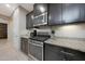 Modern kitchen with stainless steel appliances, granite countertops and dark cabinets at 10746 W Desert Elm Ln, Peoria, AZ 85383