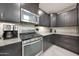 Close-up of modern kitchen with stainless steel appliances and granite countertops at 10746 W Desert Elm Ln, Peoria, AZ 85383