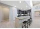 Modern kitchen featuring granite countertops, island with breakfast bar, and dark wood cabinets at 10746 W Desert Elm Ln, Peoria, AZ 85383
