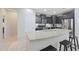 Bright kitchen features an island with breakfast bar, granite countertops, and modern appliances at 10746 W Desert Elm Ln, Peoria, AZ 85383