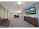 Open-concept living room with comfortable seating, carpet and a wall-mounted TV at 10746 W Desert Elm Ln, Peoria, AZ 85383