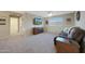 Spacious living room with carpet floors, ceiling fan and large mounted TV at 10746 W Desert Elm Ln, Peoria, AZ 85383