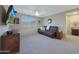 Inviting living room with comfortable seating, ceiling fan and wall mounted TV at 10746 W Desert Elm Ln, Peoria, AZ 85383