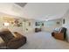 Large living room with comfortable seating, ceiling fan, carpet floors and mounted TV at 10746 W Desert Elm Ln, Peoria, AZ 85383