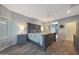 This spacious main bedroom features wood floors, a ceiling fan, and an ensuite entrance at 10746 W Desert Elm Ln, Peoria, AZ 85383