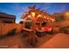 Inviting outdoor living space with a pergola, string lights, and comfortable seating around a fire pit at 10746 W Desert Elm Ln, Peoria, AZ 85383