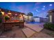 Inviting backyard with pool, pergola, and string lights, perfect for evening relaxation and outdoor entertaining at 10746 W Desert Elm Ln, Peoria, AZ 85383