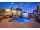 Sparkling swimming pool with accent lighting, set in a private backyard with lush landscaping at 10746 W Desert Elm Ln, Peoria, AZ 85383