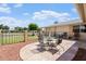 Outdoor living with wrought iron table and chairs, mature landscaping, and privacy fence at 10839 W Peoria Ave, Sun City, AZ 85351