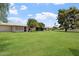 Beautiful lawn view of homes featuring mature trees and screened-in porches at 10839 W Peoria Ave, Sun City, AZ 85351