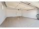 Spacious two-car garage with epoxy flooring, automatic door, and ample lighting at 10839 W Peoria Ave, Sun City, AZ 85351