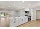 Modern kitchen with an island, sleek appliances, tile backsplash, and open floor plan at 10839 W Peoria Ave, Sun City, AZ 85351