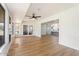 Open living room featuring wood floors and a view into the modern kitchen at 10839 W Peoria Ave, Sun City, AZ 85351