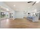 Bright open-concept living space with a breakfast bar, modern fan, recessed lighting and vinyl plank flooring at 10839 W Peoria Ave, Sun City, AZ 85351